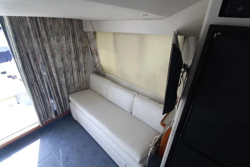 Slide: The Image of Interior of 1995 Carver 370 Voyager with white sofa and wall-mounted TV. - 31