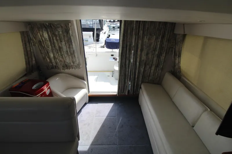 Slide: The Image of Interior of 1995 Carver 370 Voyager yacht with seating and open deck view. - 32