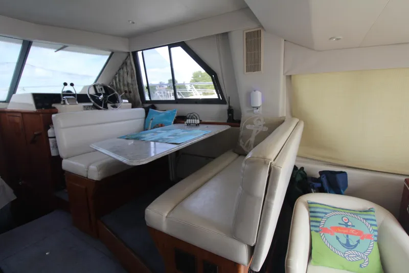 Slide: The Image of Interior of 1995 Carver 370 Voyager yacht with dining area and helm. - 34