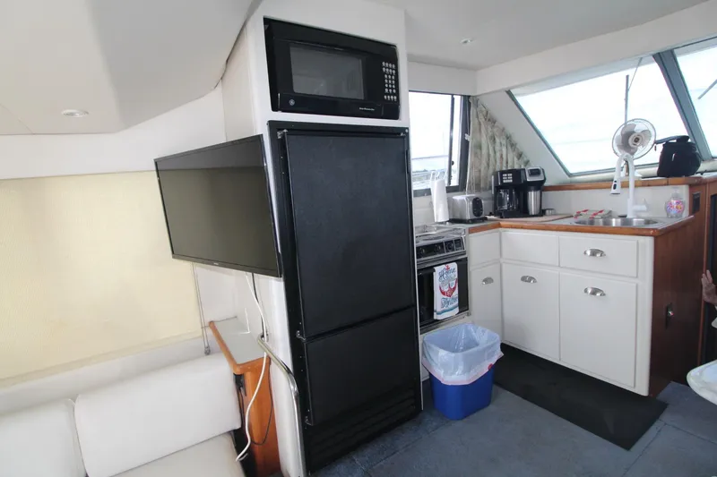 Slide: The Image of Interior of 1995 Carver 370 Voyager yacht with kitchen appliances and cabinetry. - 35