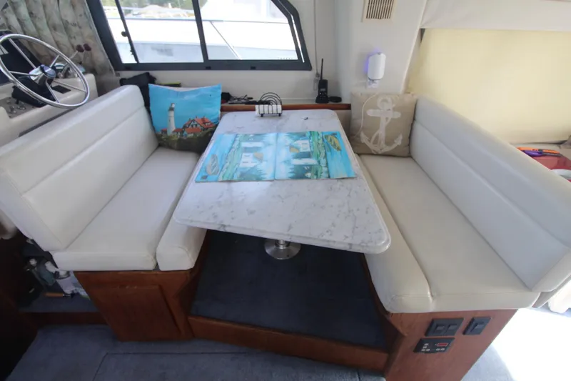 Slide: The Image of Interior of 1995 Carver 370 Voyager with white seating and a marble table. - 36