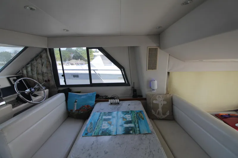 Slide: The Image of Interior of 1995 Carver 370 Voyager yacht with seating and helm. - 37