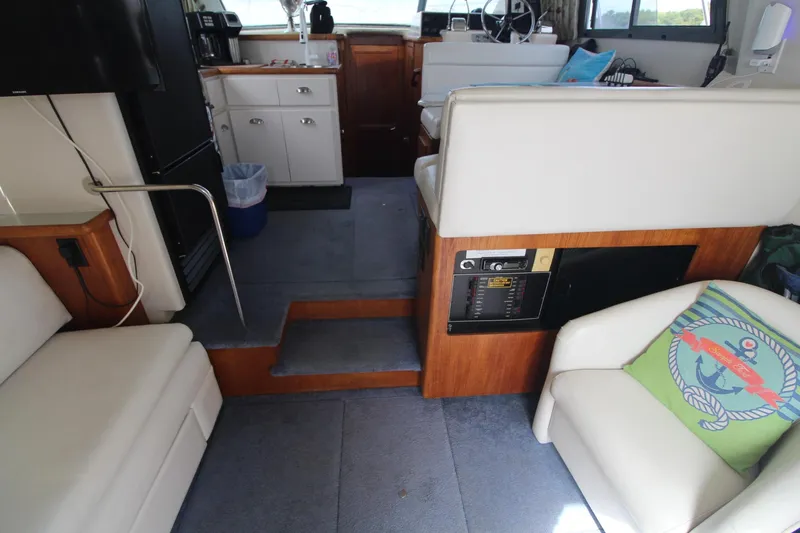 Slide: The Image of Interior of 1995 Carver 370 Voyager yacht with seating, kitchenette, and helm. - 39