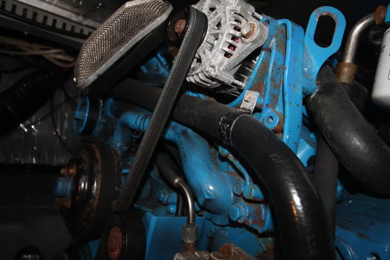 Slide: The Image of Engine components of a 1995 Carver 370 Voyager boat, featuring belts and hoses. - 44