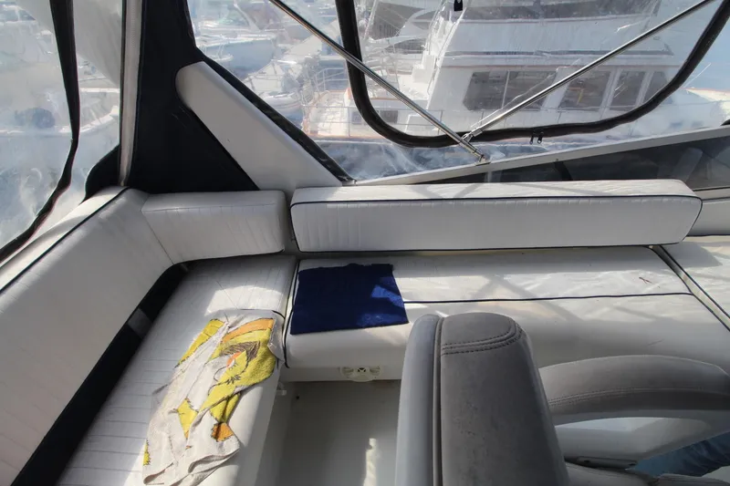 Slide: The Image of Interior of a 1995 Carver 370 Voyager yacht with white seating and windows. - 6