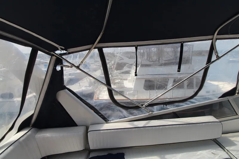 Slide: The Image of Interior view of a 1995 Carver 370 Voyager yacht with cushioned seating and clear windows. - 7