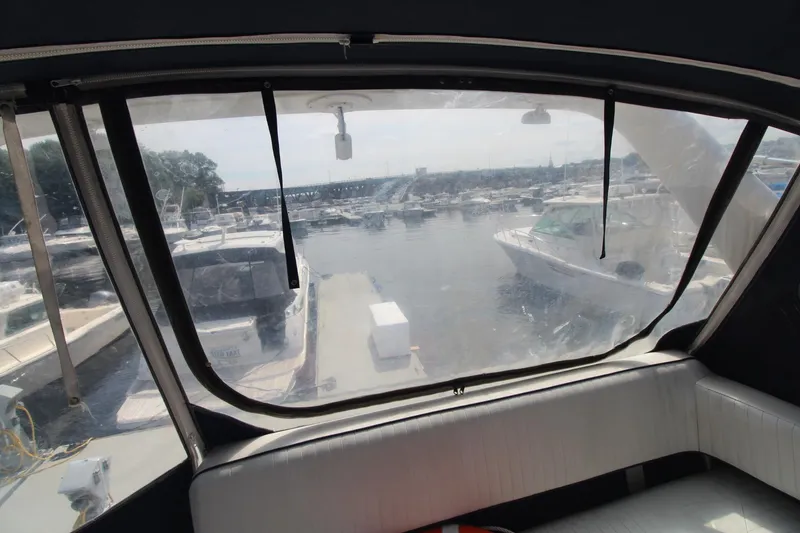 Slide: The Image of Interior view from a 1995 Carver 370 Voyager, overlooking a marina with multiple boats. - 8