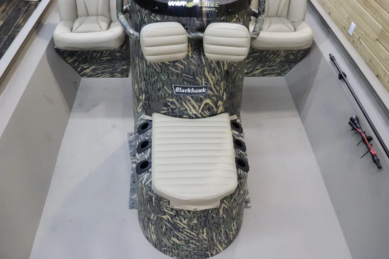 Slide: The Image of 2025 War Eagle 2170 Blackhawk boat interior with camo design and seating. - 13