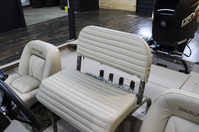 Slide: The Image of 2025 War Eagle 2170 Blackhawk boat interior with beige seating and motor. - 15