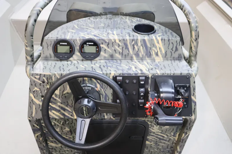 Slide: The Image of 2025 War Eagle 2170 Blackhawk boat console with steering wheel and controls. - 17