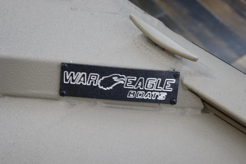 Slide: The Image of War Eagle 2170 Blackhawk 2025 boat logo on beige surface. - 27