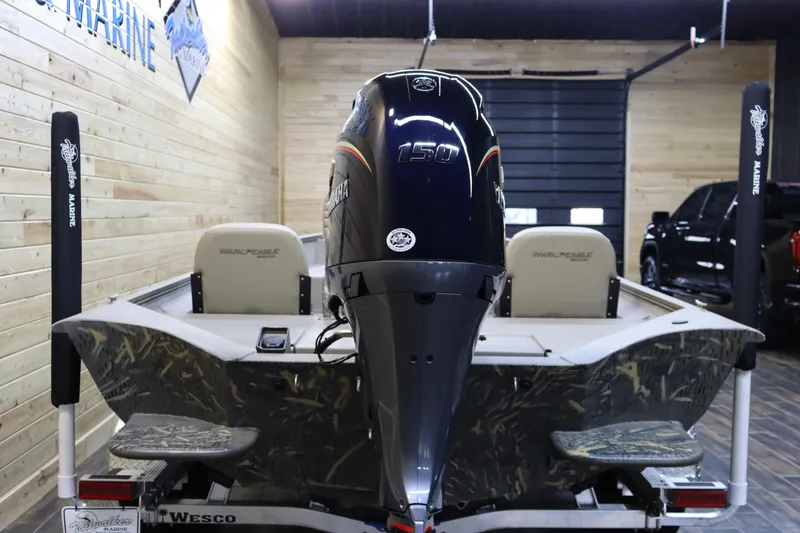 Slide: The Image of 2025 War Eagle 2170 Blackhawk boat with powerful outboard motor in showroom. - 3