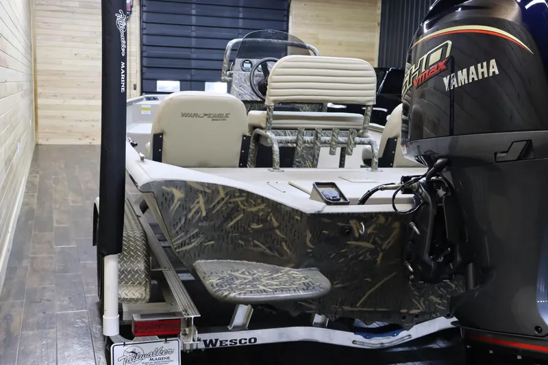 Slide: The Image of 2025 War Eagle 2170 Blackhawk boat with Yamaha engine on trailer in garage. - 5