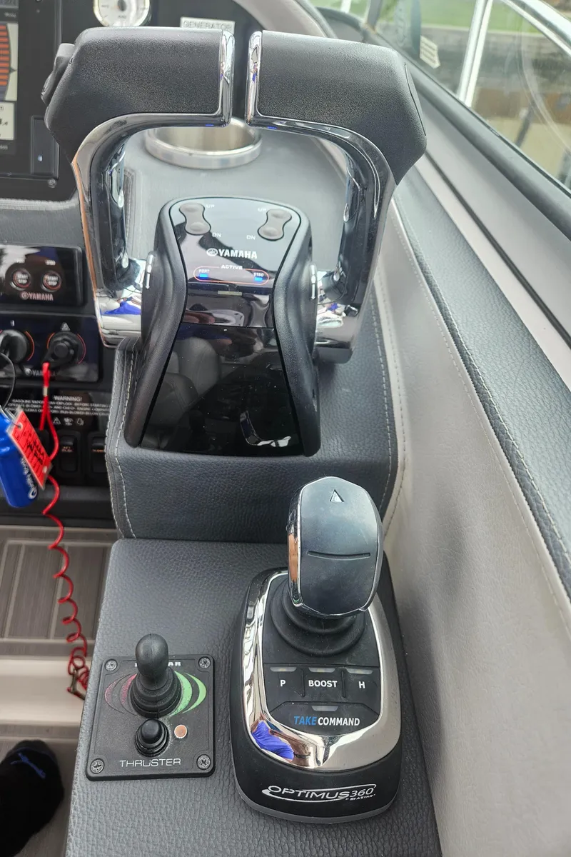 Slide: The Image of 2022 Regal 33 XO boat controls and joystick in cockpit. - 12