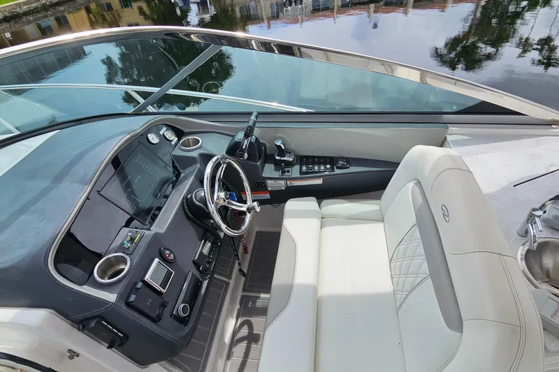 Slide: The Image of 2022 Regal 33 XO boat cockpit with modern controls and luxurious seating. - 14