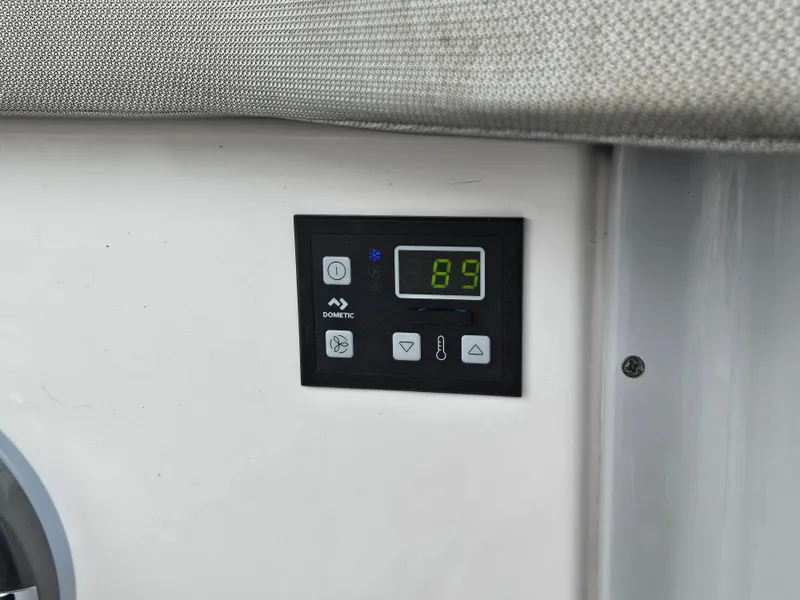 Slide: The Image of Control panel on 2022 Regal 33 XO boat displaying temperature settings. - 16