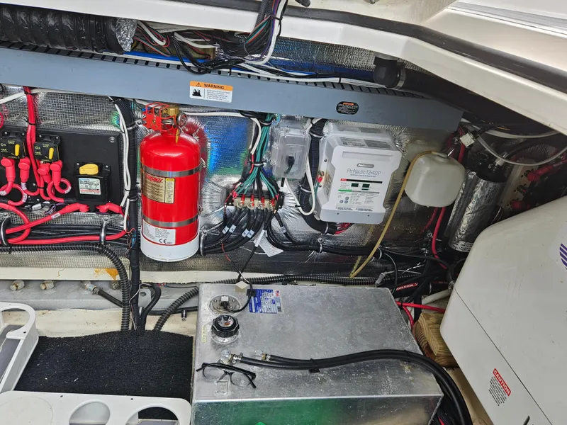 Slide: The Image of Engine compartment of 2022 Regal 33 XO boat with fire extinguisher and electrical components. - 21