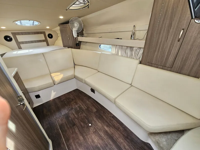 Slide: The Image of Luxurious interior of 2022 Regal 33 XO boat with beige seating and wood accents. - 23