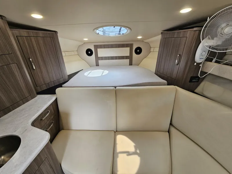 Slide: The Image of Interior of 2022 Regal 33 XO yacht with modern furnishings and natural light. - 24