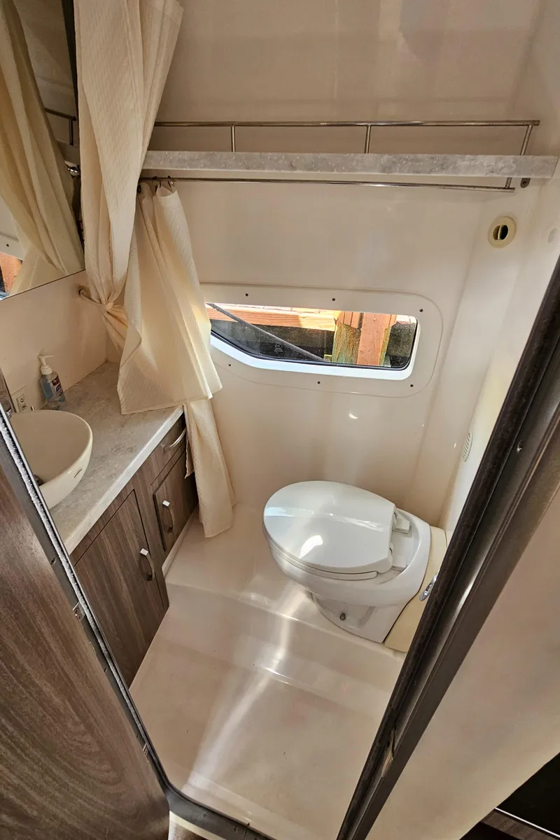 Slide: The Image of 2022 Regal 33 XO boat bathroom with modern fixtures and window. - 29