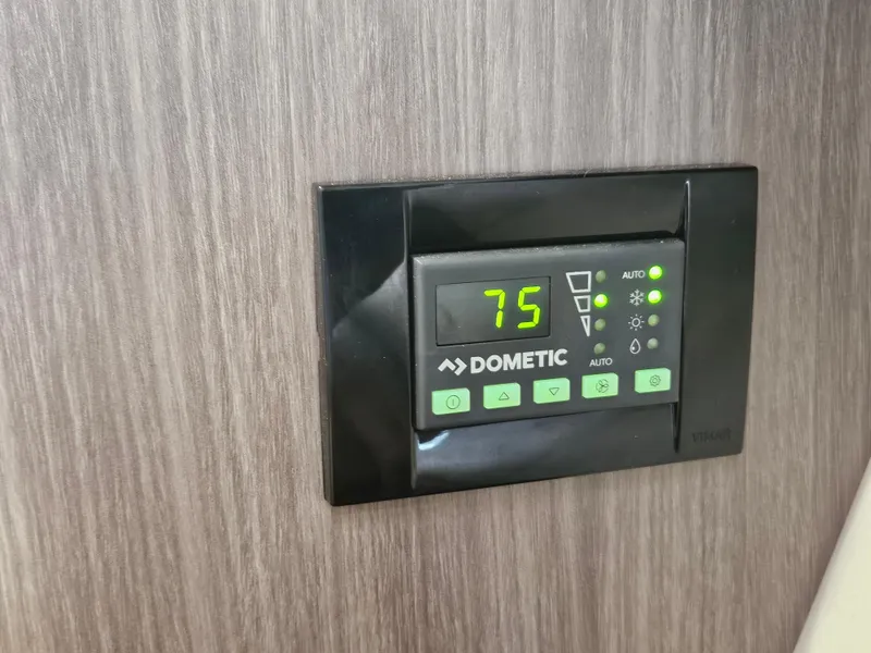 Slide: The Image of Dometic thermostat on 2022 Regal 33 XO boat, displaying 75 degrees. - 31