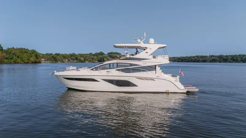 Slide: The Image of 2018 Sea Ray L550 Fly yacht cruising on a serene lake. - 0