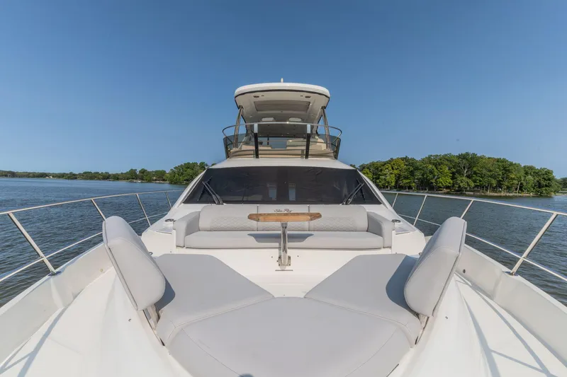 Slide: The Image of 2018 Sea Ray L550 Fly yacht with spacious deck and seating, cruising on a sunny day. - 15