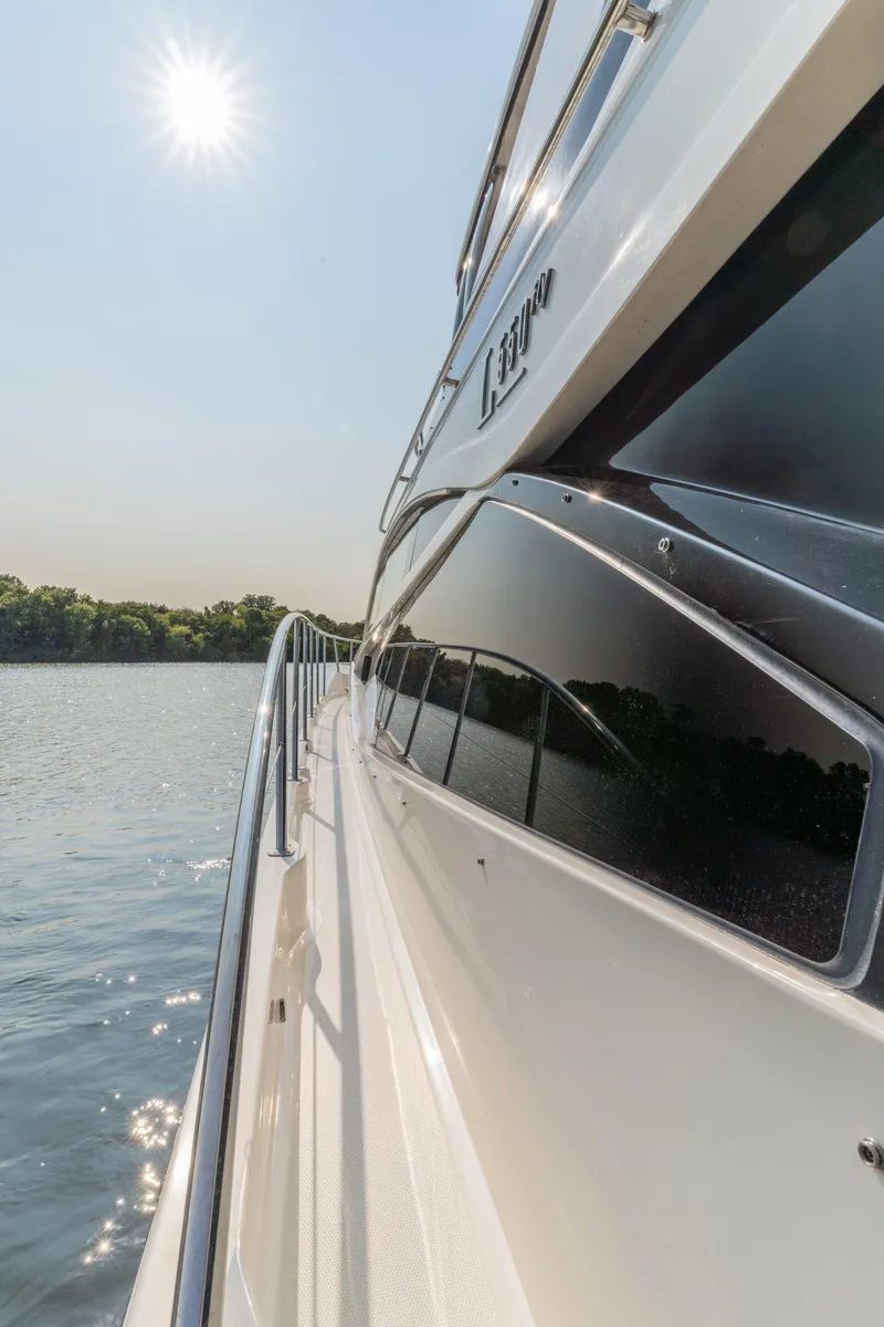 Slide: The Image of Side view of 2018 Sea Ray L550 Fly yacht on a sunny day. - 16