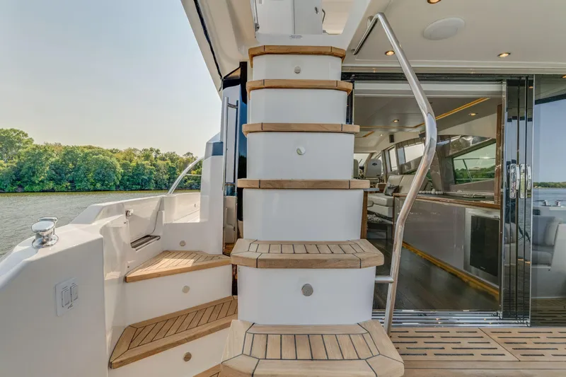 Slide: The Image of 2018 Sea Ray L550 Fly yacht with elegant wooden stairs and modern interior. - 18