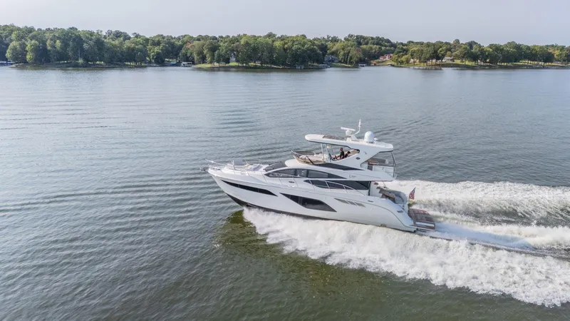 Slide: The Image of 2018 Sea Ray L550 Fly yacht cruising on a serene lake. - 3