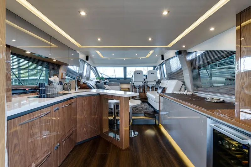 Slide: The Image of Luxurious interior of 2018 Sea Ray L550 Fly yacht with modern kitchen and seating area. - 30