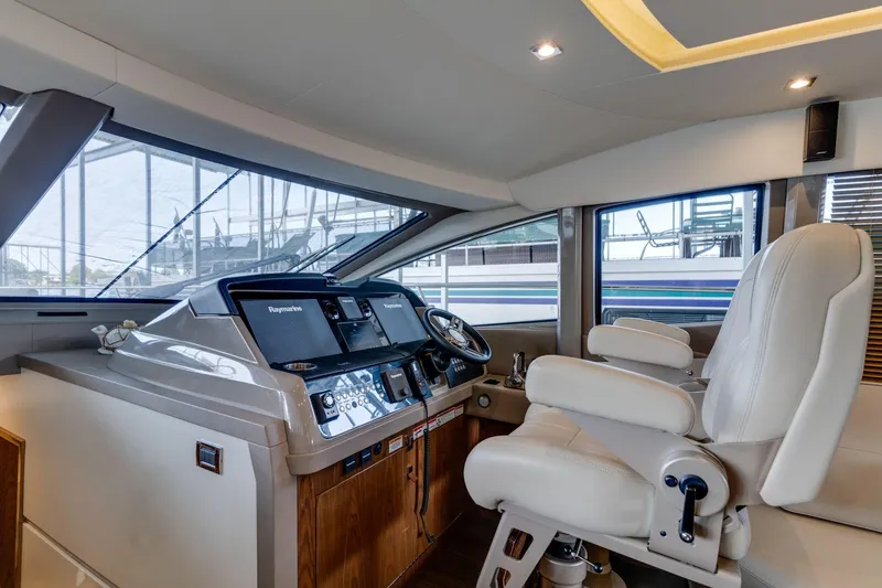 Slide: The Image of Luxurious 2018 Sea Ray L550 Fly yacht helm with modern controls and plush seating. - 41