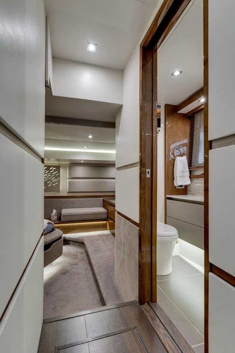 Slide: The Image of Luxurious interior of 2018 Sea Ray L550 Fly yacht, featuring modern bathroom and seating area. - 45