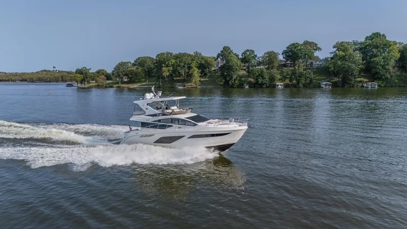 Slide: The Image of 2018 Sea Ray L550 Fly yacht cruising on a serene lake. - 7