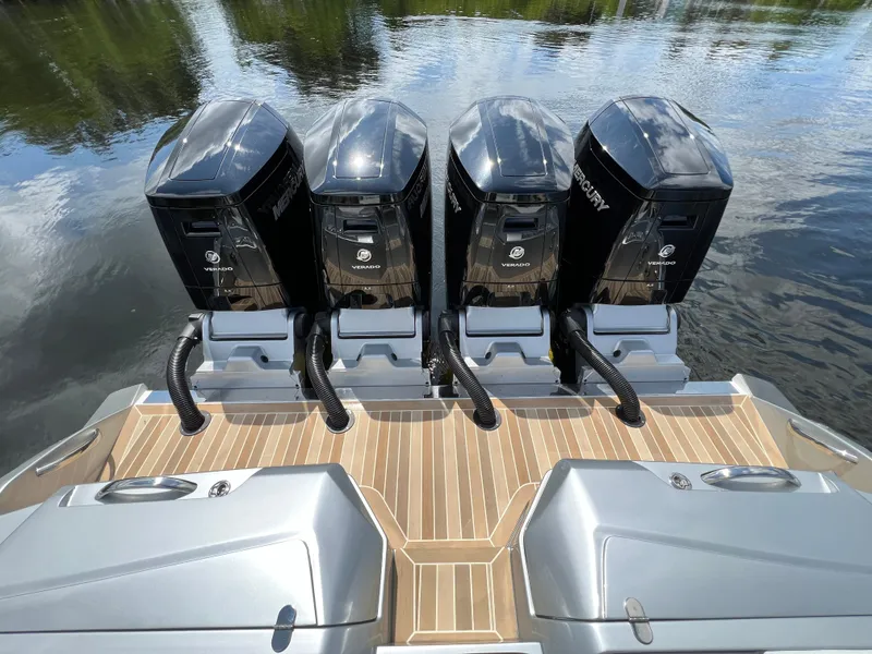Slide: The Image of 2024 Nor-Tech 500 Sport boat with four powerful outboard engines on a sleek deck. - 13