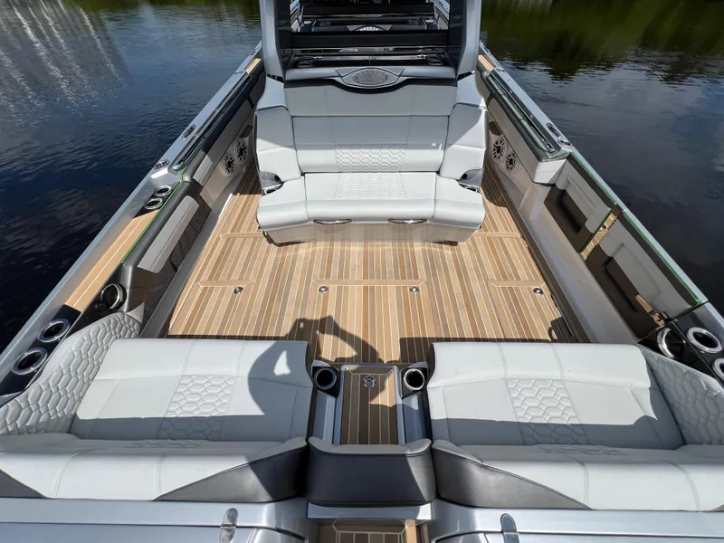 Slide: The Image of 2024 Nor-Tech 500 Sport boat interior with luxurious seating and wood flooring. - 14