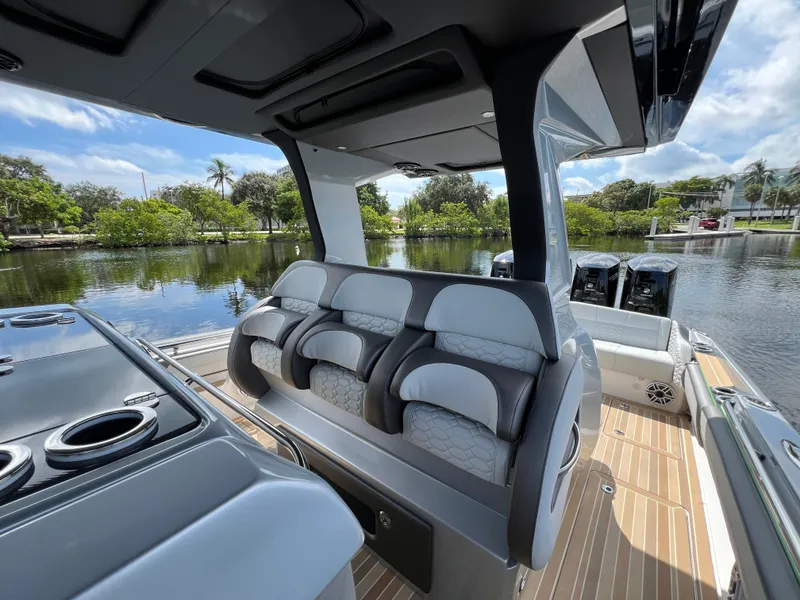 Slide: The Image of 2024 Nor-Tech 500 Sport boat interior with luxurious seating and scenic water view. - 17