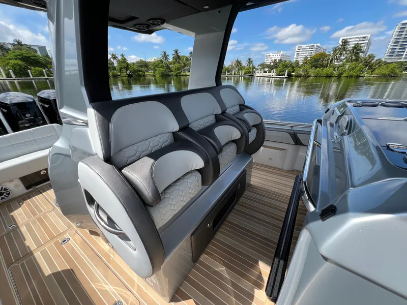 Slide: The Image of 2024 Nor-Tech 500 Sport boat interior with luxurious seating and scenic waterfront view. - 18