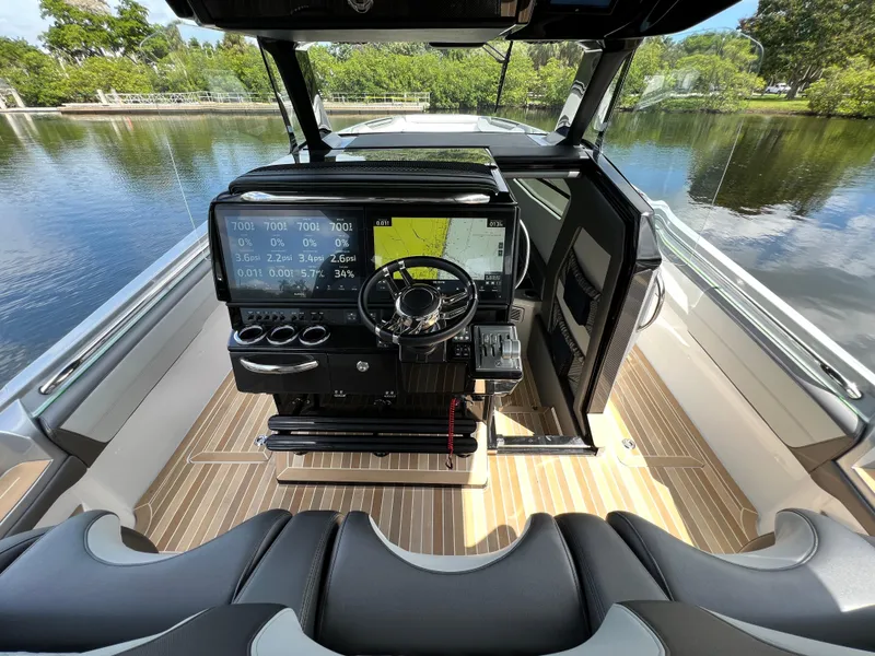Slide: The Image of 2024 Nor-Tech 500 Sport boat cockpit with advanced navigation system and luxurious seating. - 20