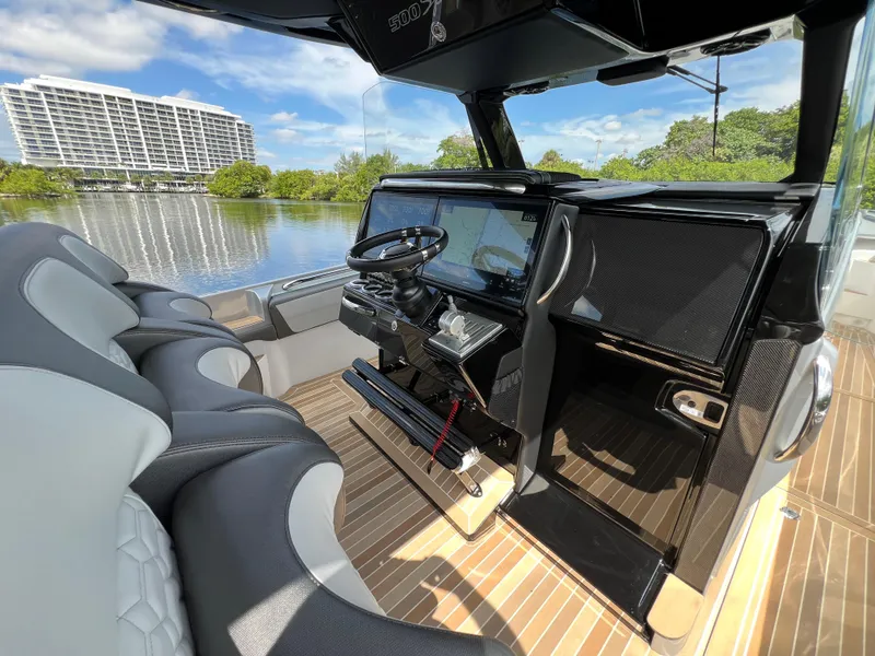 Slide: The Image of 2024 Nor-Tech 500 Sport boat interior with modern dashboard and luxurious seating. - 21