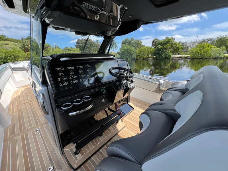 Slide: The Image of 2024 Nor-Tech 500 Sport boat interior with sleek dashboard and comfortable seating. - 22