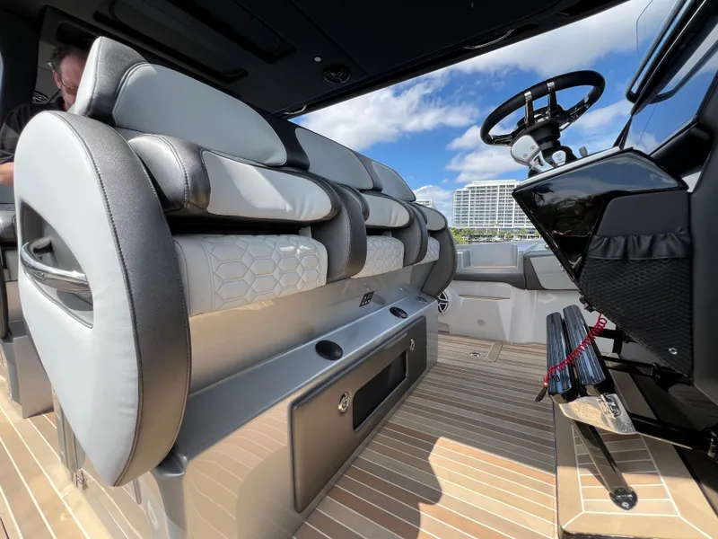 Slide: The Image of 2024 Nor-Tech 500 Sport boat interior with luxurious seating and modern steering console. - 25