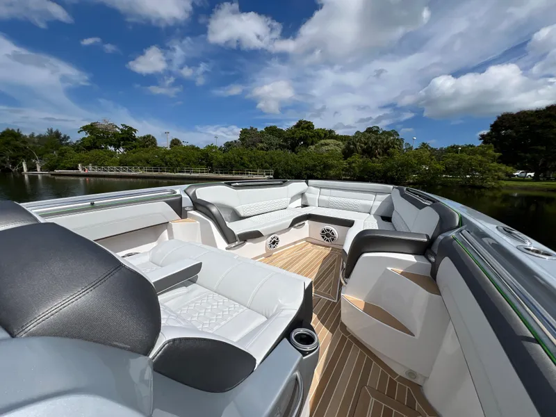 Slide: The Image of 2024 Nor-Tech 500 Sport boat interior with luxurious seating and scenic water view. - 29