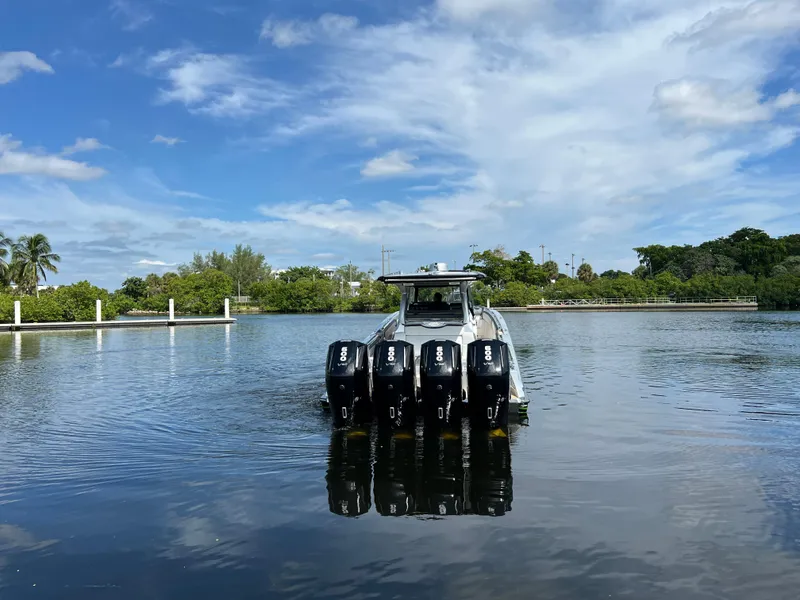 Slide: The Image of 2024 Nor-Tech 500 Sport boat with four engines on a calm lake. - 3