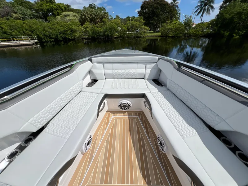 Slide: The Image of 2024 Nor-Tech 500 Sport boat interior with luxurious seating and wood flooring. - 30