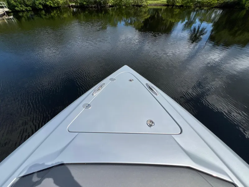 Slide: The Image of 2024 Nor-Tech 500 Sport boat on calm water, showcasing sleek bow design. - 31