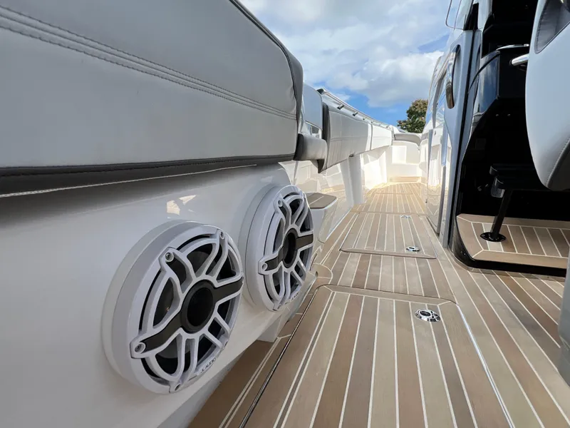 Slide: The Image of 2024 Nor-Tech 500 Sport boat deck with speakers and sleek design. - 34