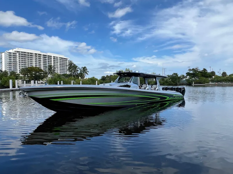 Slide: The Image of 2024 Nor-Tech 500 Sport boat on calm water with modern buildings in the background. - 7