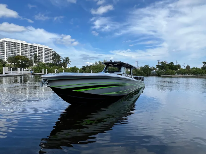 Slide: The Image of 2024 Nor-Tech 500 Sport boat on calm water with a scenic backdrop. - 8