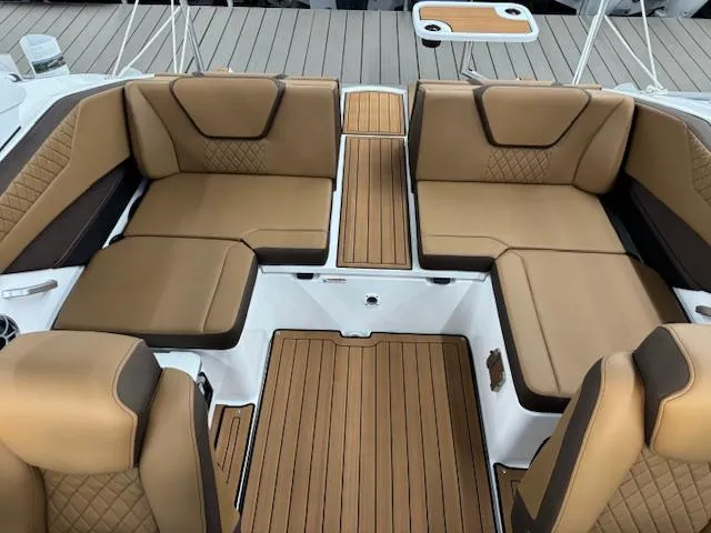 Slide: The Image of Luxurious interior of 2025 Yamaha Boats 222S with tan leather seating and teak flooring. - 10